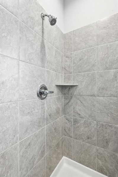 Full bathroom featuring a tile shower
