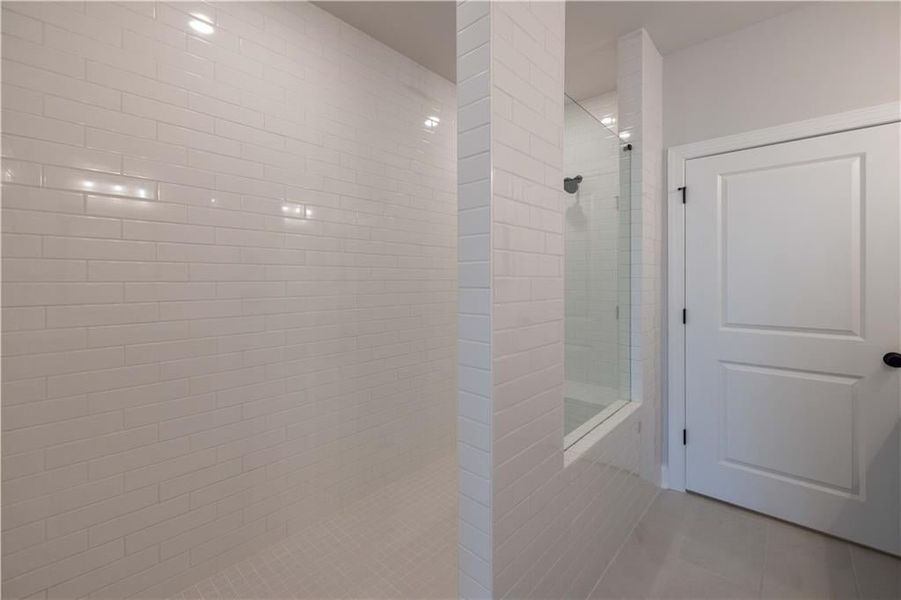 The large walk in shower. *Please note that pictures shown are of the Jacobsen II floorplan but they are not of the actual home listed.