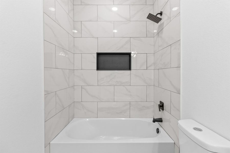 Bathroom featuring  shower combination and toilet