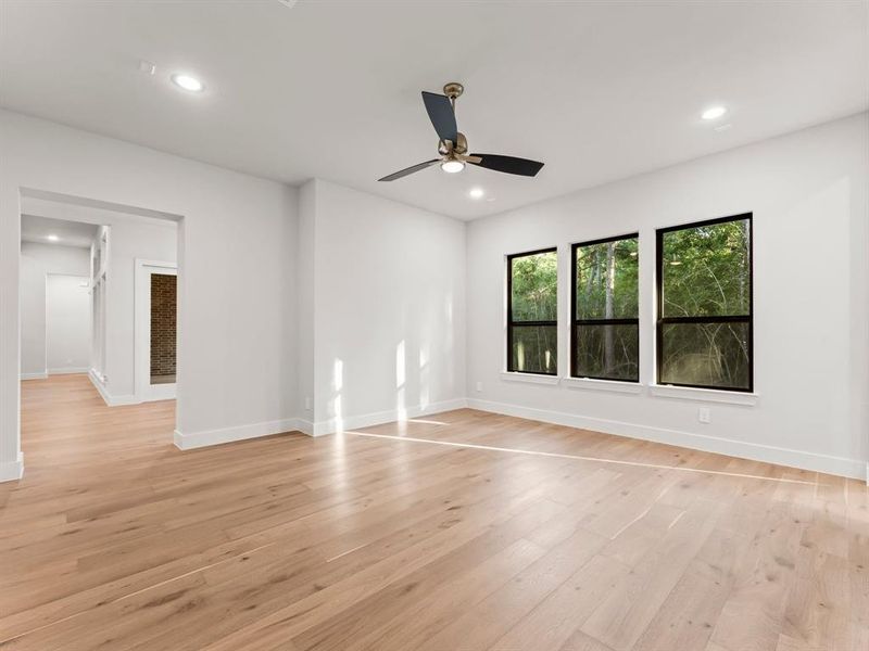 Game Room with Engineered Hardwood Flooring and Fan Next to the Breakfast Area