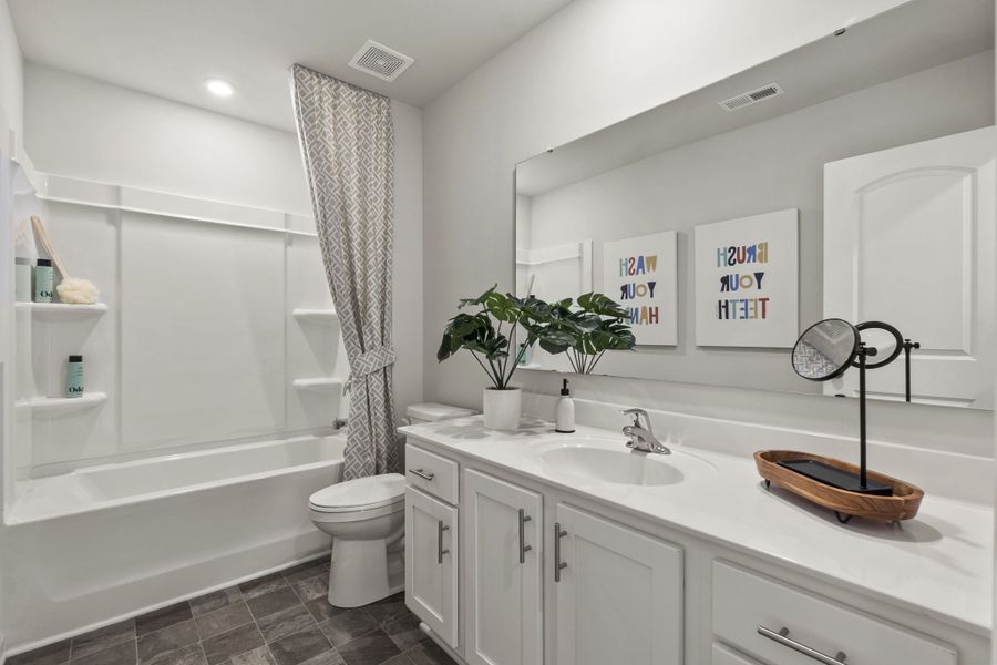 A bathroom with a tub sink and toilet.
