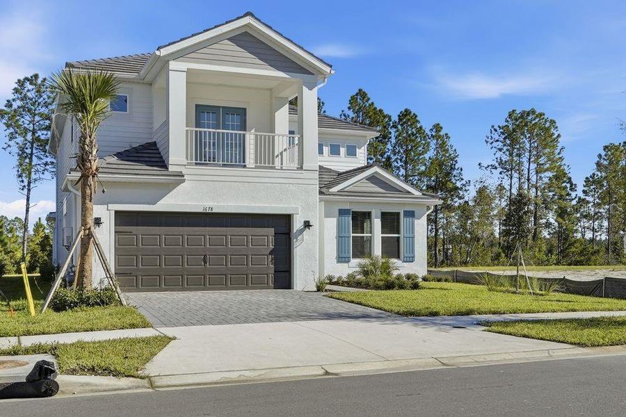 Front exterior of a new home in Hammock at Two Rivers, Zephyrhills, FL, highlighting curb appeal (Image 1). Front exterior of a new home in Hammock at Two Rivers, Zephyrhills, FL, highlighting curb appeal (Image 1).