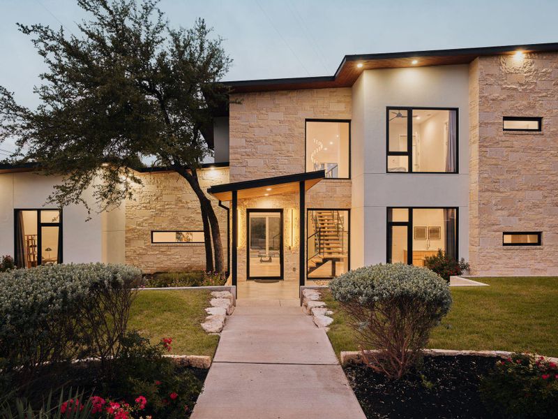 Modern architecture with a mix of natural stone and smooth stucco finishes creates a compelling facade. Modern architecture with a mix of natural stone and smooth stucco finishes creates a compelling facade.