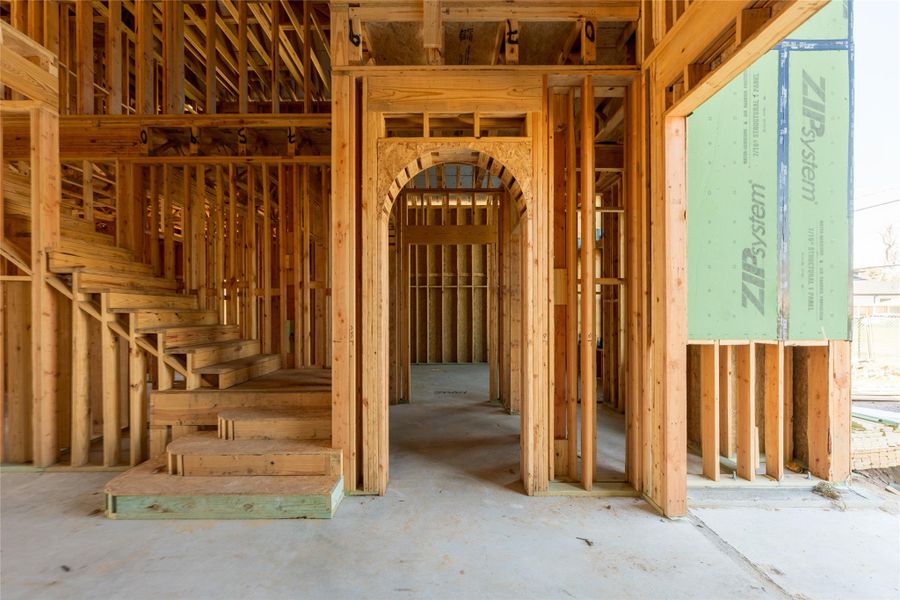 A glimpse into the future flow of the home, where framed archways guide movement and create moments of transition. The structure already suggests a layout that will feel layered, intentional, and effortlessly connected.