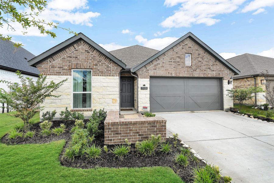 Front exterior of a new home in Bridgeland Creekland Village, Cypress, TX, highlighting curb appeal (Image 19). Front exterior of a new home in Bridgeland Creekland Village, Cypress, TX, highlighting curb appeal (Image 19).