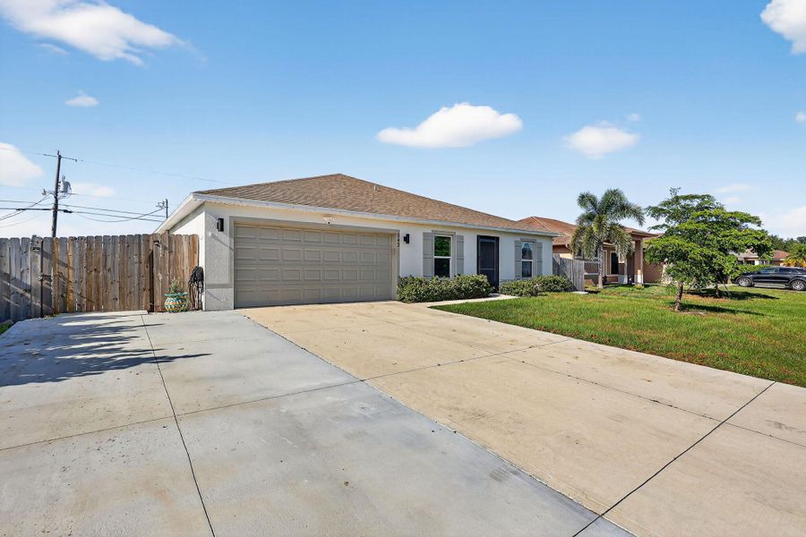 Front exterior of a new home in , Port St. Lucie, FL, highlighting curb appeal (Image 21).