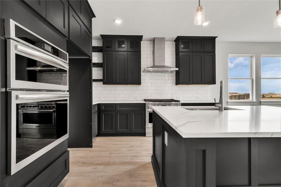 Modern kitchen with white quartz countertops and stylish dark cabinetry.
