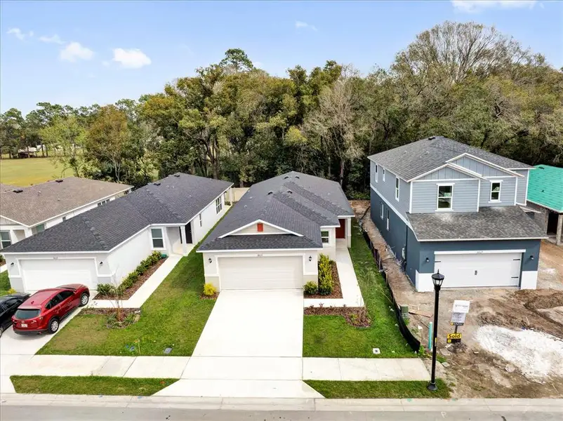 Front exterior of a new home in Wilder Pines, Lakeland, FL, highlighting curb appeal (Image 2). Front exterior of a new home in Wilder Pines, Lakeland, FL, highlighting curb appeal (Image 2).