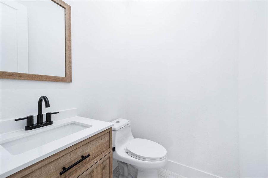 Chic powder room featuring an eco-friendly, high-efficiency dual-flush toilet.