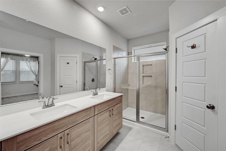 Bathroom with plenty of natural light, a stall shower, and double vanity Bathroom with plenty of natural light, a stall shower, and double vanity