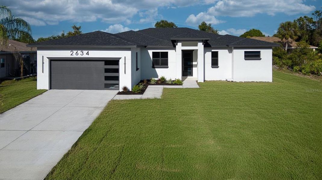Front exterior of a new home in , North Port, FL, highlighting curb appeal (Image 1). Front exterior of a new home in , North Port, FL, highlighting curb appeal (Image 1).