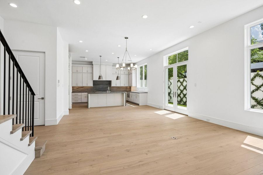 The stunning first floor was designed with relaxation and entertaining in mind! Spacious enough for ample seating surrounding the fireplace, a large dining table, and an island with additional seating that overlooks the living space. Additionally, elevator shaft is off of the living room for future elevator installation, but can be used as large storage closet.