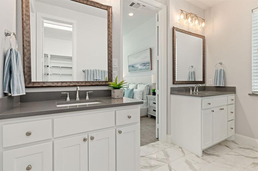 Primary bathroom with tile floors and double vanity