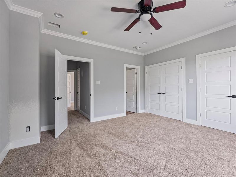 Unfurnished bedroom with carpet floors, crown molding, baseboards, a closet, and recessed lighting