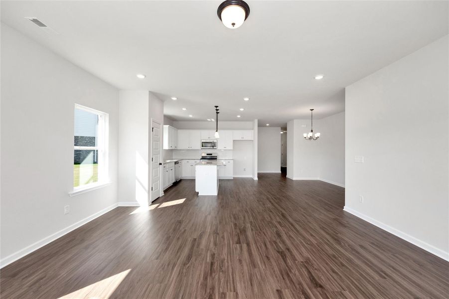 The Pearson- Family Room into Kitchen. Home under construction. Sample floor plan photo used for illustrative purposes only. Upgrades, selections options, and colors will vary. The Pearson- Family Room into Kitchen. Home under construction. Sample floor plan photo used for illustrative purposes only. Upgrades, selections options, and colors will vary.