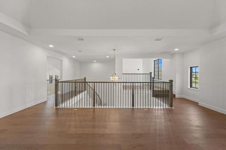 Unfurnished room featuring recessed lighting, a chandelier, and hardwood / wood-style flooring
