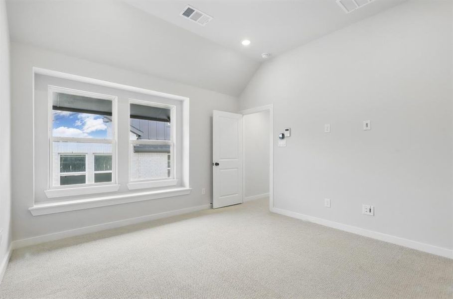 Spare room with carpet flooring, vaulted ceiling, and recessed lighting