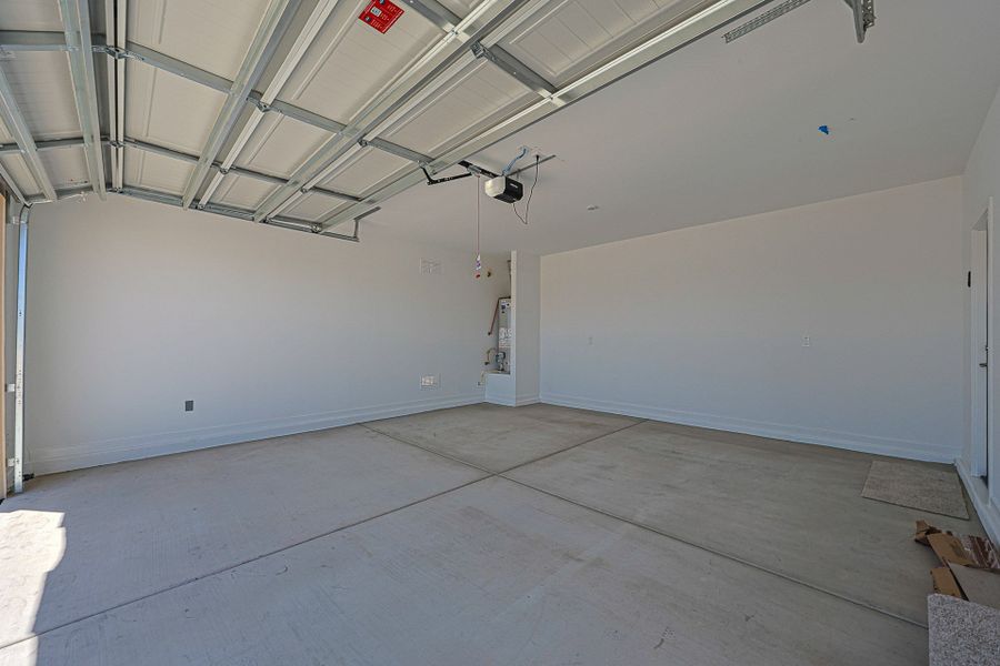 A room with a tile floor and a white wall with a red sign. A room with a tile floor and a white wall with a red sign.