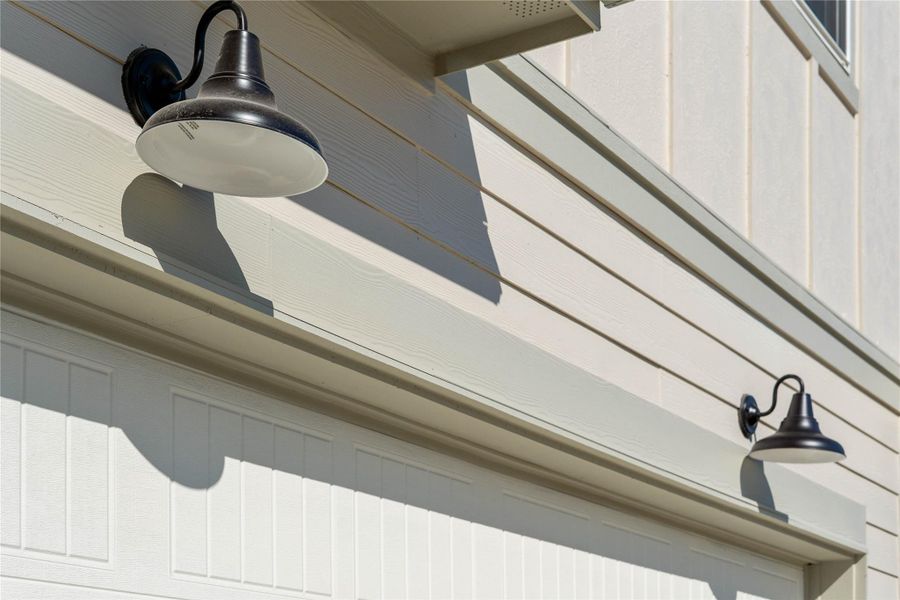 The property features stylish matte black gooseneck barn lights - providing ample illumination for safety and ambiance.