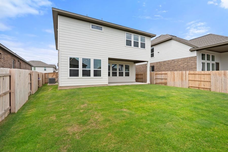 Front exterior of a new home in Arbor Collection at Lariat, Liberty Hill, TX, highlighting curb appeal (Image 26). Front exterior of a new home in Arbor Collection at Lariat, Liberty Hill, TX, highlighting curb appeal (Image 26).