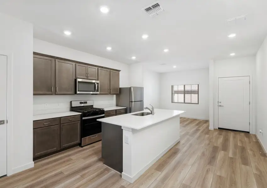 The spacious kitchen seamlessly connects to a separate dining area.