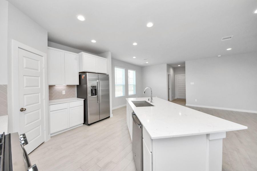 This generously spacious kitchen is a dream realized! Sample photo of completed home with similar floor plan. Actual colors and selections may vary. This generously spacious kitchen is a dream realized! Sample photo of completed home with similar floor plan. Actual colors and selections may vary.