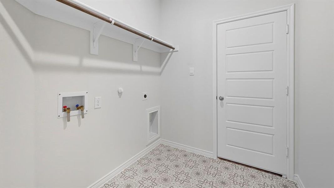 Laundry room featuring hookup for a gas dryer, washer hookup, hookup for an electric dryer, and tile patterned floors Laundry room featuring hookup for a gas dryer, washer hookup, hookup for an electric dryer, and tile patterned floors