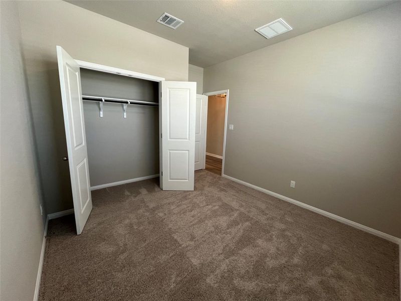 Front bedroom. High ceilings and soft carpeting create a comfortable atmosphere in this secondary bedroom. Front bedroom. High ceilings and soft carpeting create a comfortable atmosphere in this secondary bedroom.