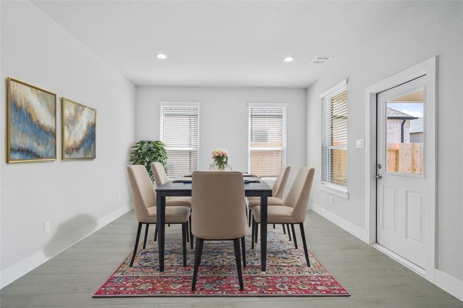 Make memories gathered around the table with your family and friends! This dining room features high ceilings, recessed lighting, large windows, and beautiful tile flooring!