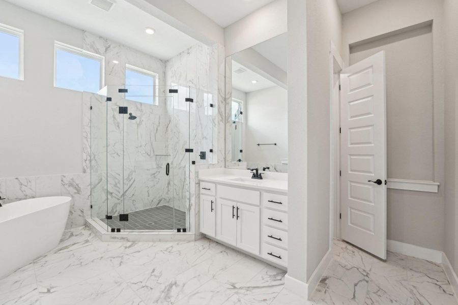 primaryl bath featuring a marble finish shower, vanity, a freestanding bath, marble finish floors, and recessed lighting primaryl bath featuring a marble finish shower, vanity, a freestanding bath, marble finish floors, and recessed lighting