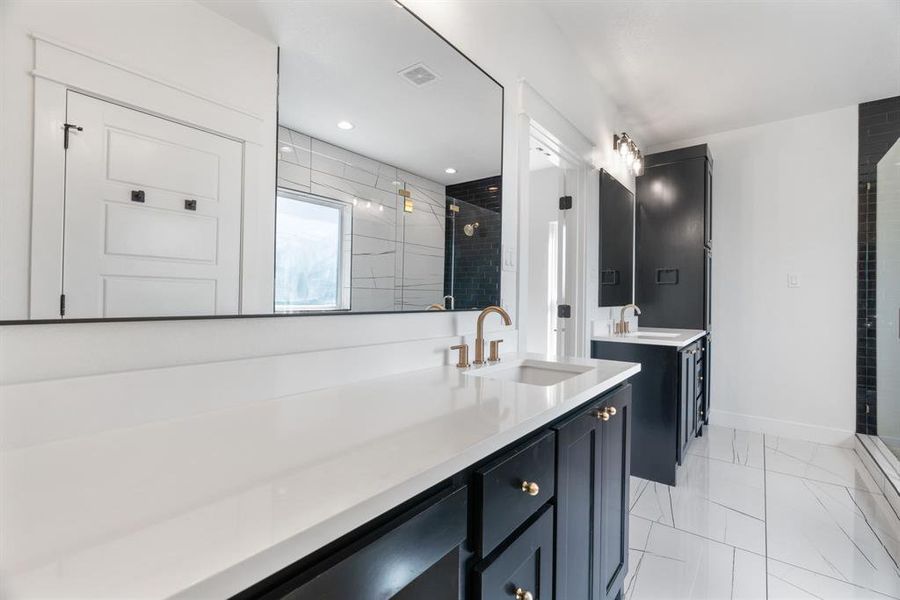 Full bath featuring a stall shower and baseboards