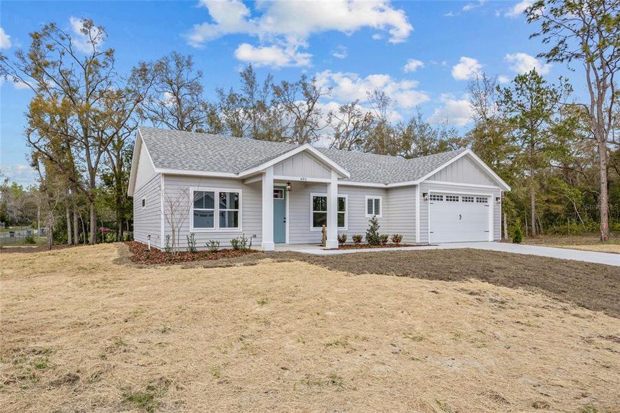 Front exterior of a new home in , Bronson, FL, highlighting curb appeal (Image 1).