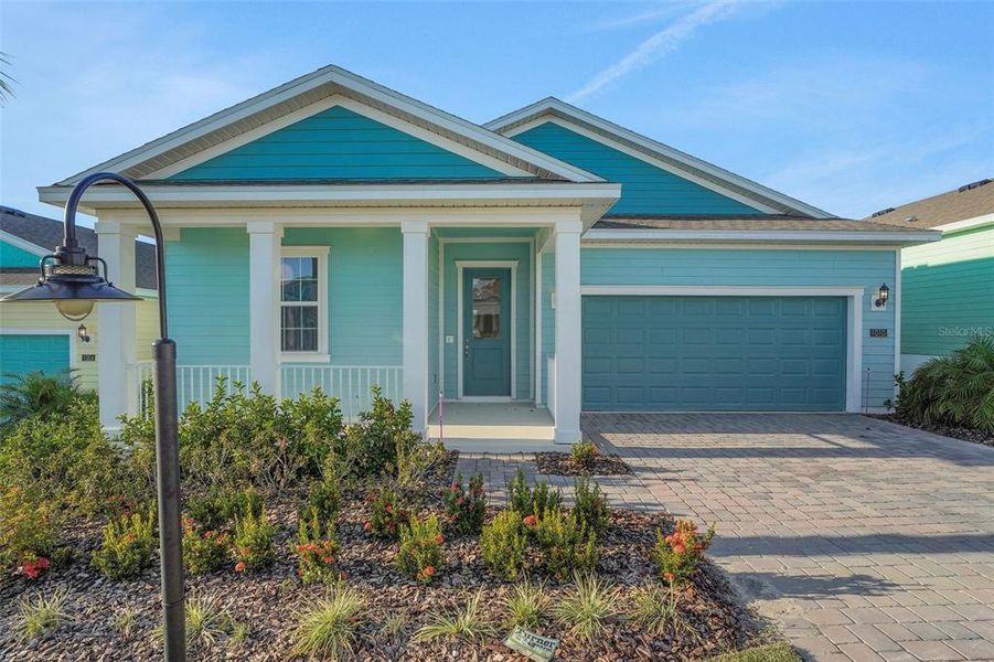 Front exterior of a new home in Green Key Village, Lady Lake, FL, highlighting curb appeal (Image 2). Front exterior of a new home in Green Key Village, Lady Lake, FL, highlighting curb appeal (Image 2).