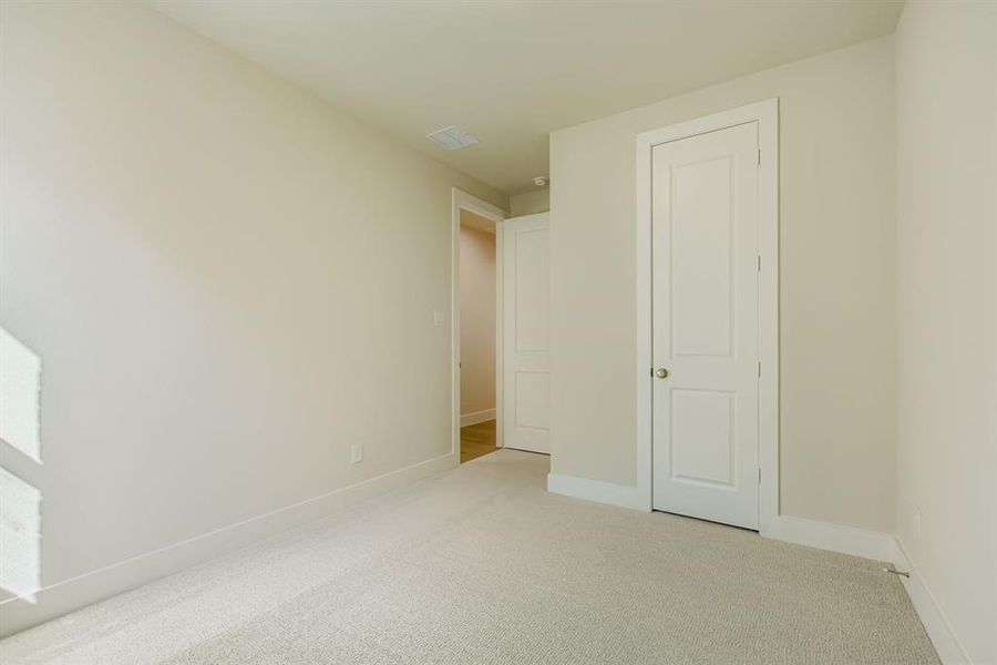 Unfurnished bedroom featuring carpet flooring and baseboards