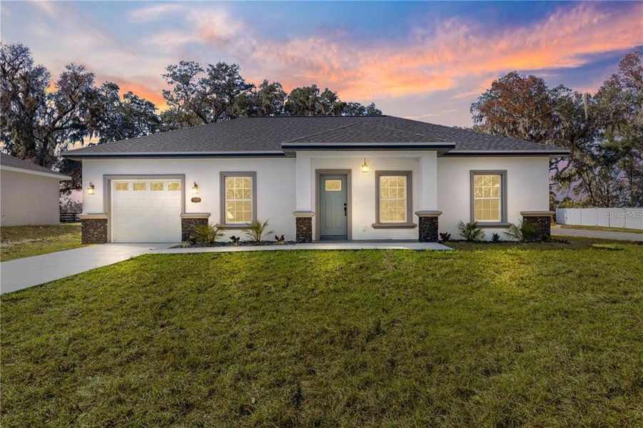 Front exterior of a new home in , Summerfield, FL, highlighting curb appeal (Image 15).