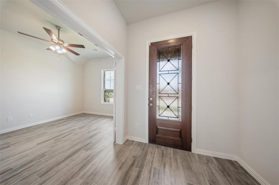 Foyer with wood finished floors and ceiling fan