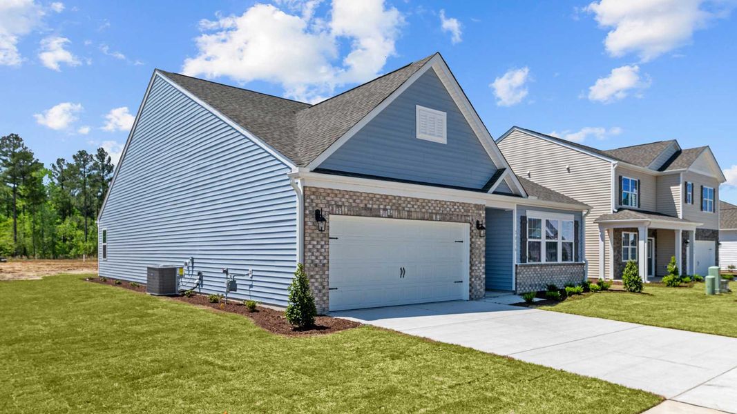 Front exterior of a new home in Villa Grande, Winterville, NC, highlighting curb appeal (Image 2). Front exterior of a new home in Villa Grande, Winterville, NC, highlighting curb appeal (Image 2).