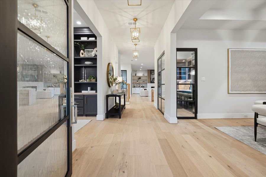 Enter through the custom, over-sized iron door to the bright foyer with study/living on your left and formal dining to your right.