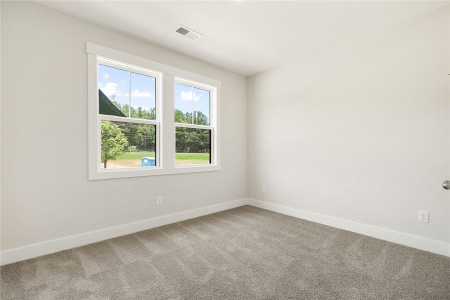 A well-lit bedroom with ample space for personaliz A well-lit bedroom with ample space for personaliz