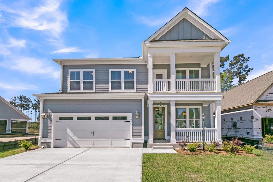 Front exterior of a new home in Tidewater at Lakes of Cane Bay, Summerville, SC, highlighting curb appeal (Image 1). Front exterior of a new home in Tidewater at Lakes of Cane Bay, Summerville, SC, highlighting curb appeal (Image 1).
