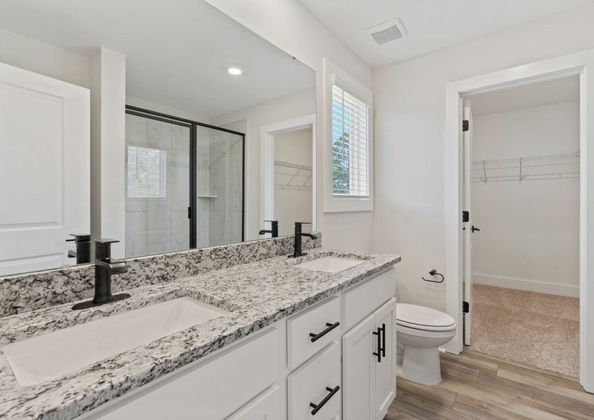 The master bathroom has dual vanities