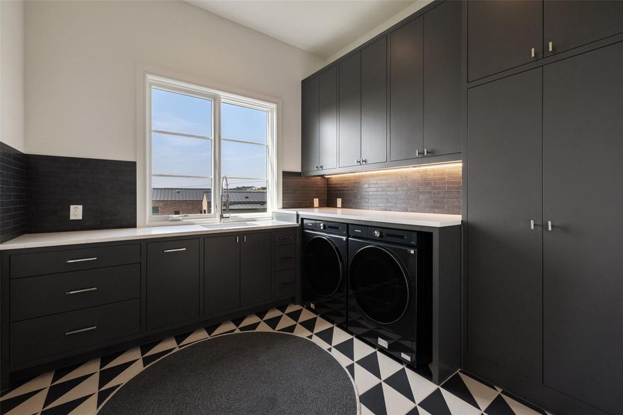 Washroom featuring light flooring, cabinet space, and washing machine and dryer Washroom featuring light flooring, cabinet space, and washing machine and dryer