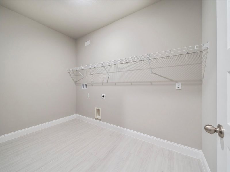 Laundry Room in the Coral floorplan at 6326 NW Sweetwood Drive in Brystol at Wylder