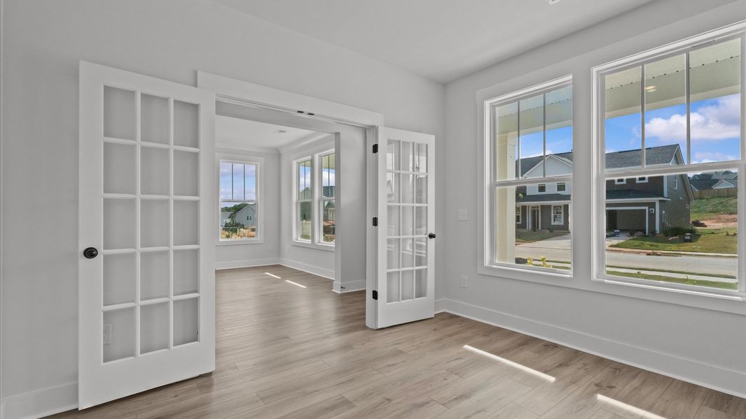 Elegant French door study with tasteful trim and abundant natural light in this first-class DRB Homes design