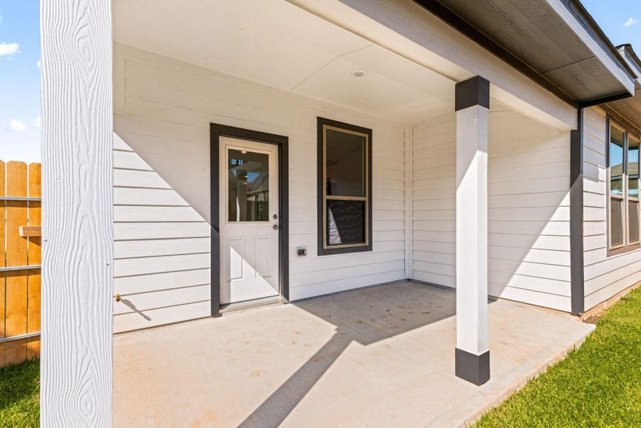 The inviting covered rear patio offers a seamless extension of indoor living to the outdoors. This space provides a perfect area for relaxation, al fresco dining, or entertaining, protected from the elements. The inviting covered rear patio offers a seamless extension of indoor living to the outdoors. This space provides a perfect area for relaxation, al fresco dining, or entertaining, protected from the elements.