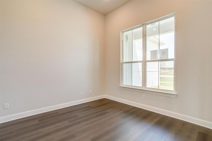 Empty room with dark hardwood / wood-style flooring