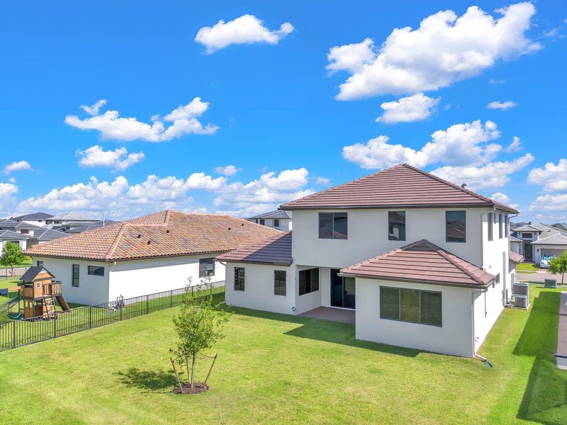 Front exterior of a new home in , Ave Maria, FL, highlighting curb appeal (Image 34).