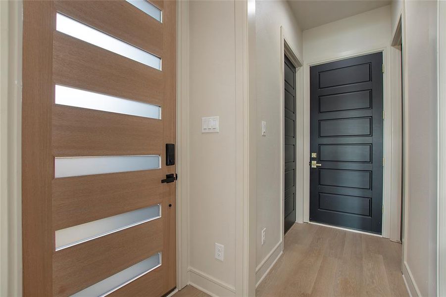 Foyer with light hardwood / wood-style flooring