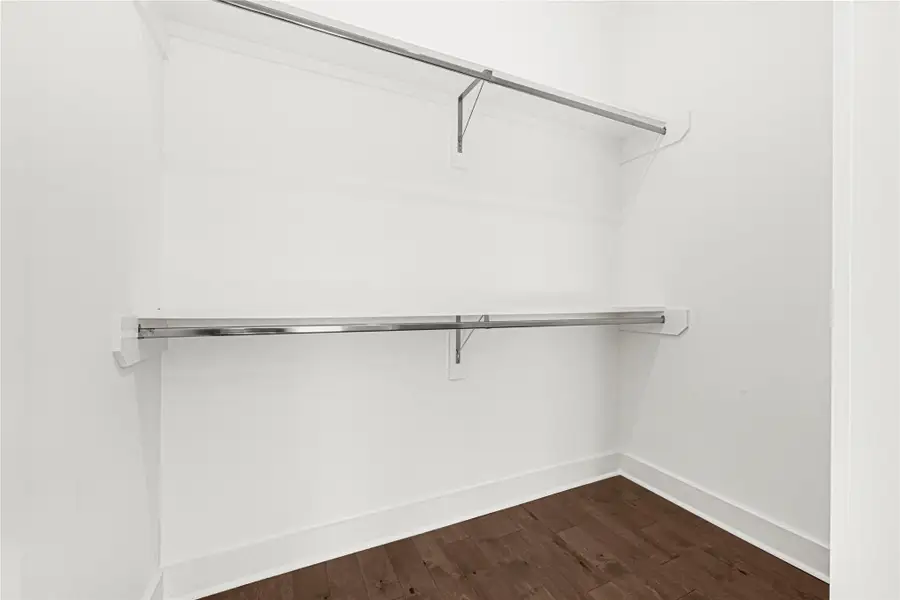 Expansive walk-in closet with ample shelving and hanging space, perfect for all your storage needs.