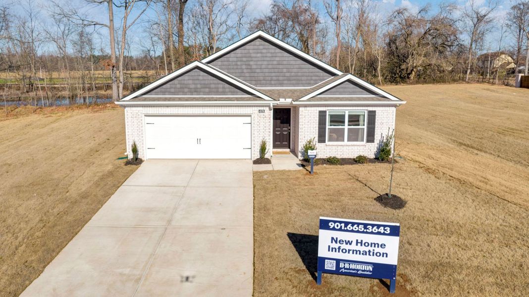 Front exterior of a new home in Riggs Pointe, Millington, TN, highlighting curb appeal (Image 20).